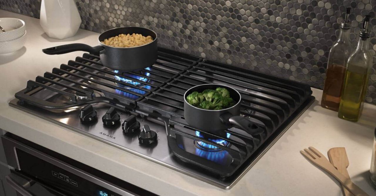 An Amana® cooktop boiling broccoli and noodles. An Amana® cooktop boiling broccoli and noodles.