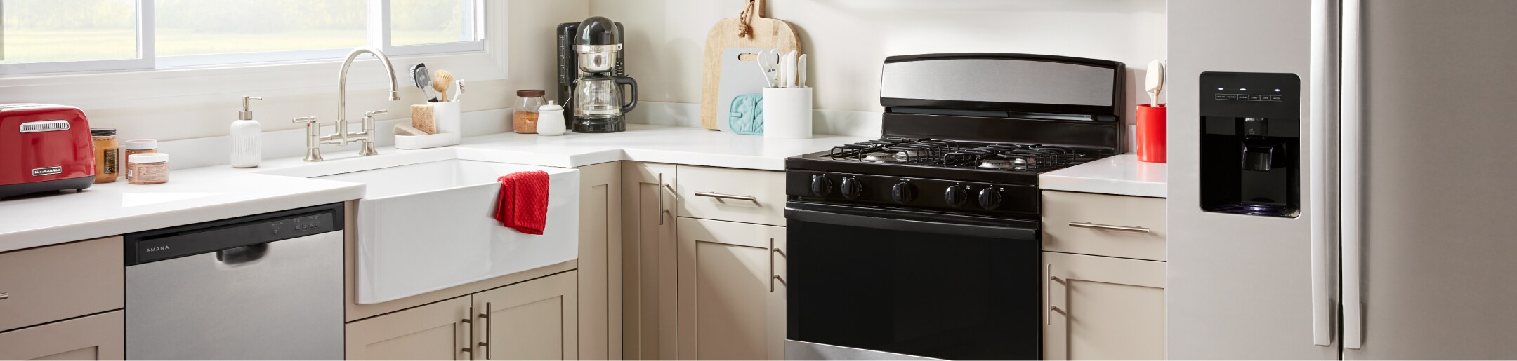 An Amana® dishwasher, range and refrigerator in a kitchen.