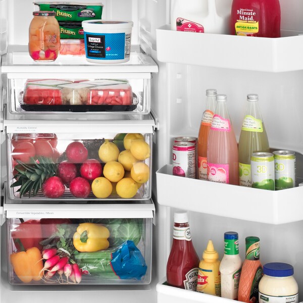 An open Amana® refrigerator with food inside. An open Amana® refrigerator with food inside.