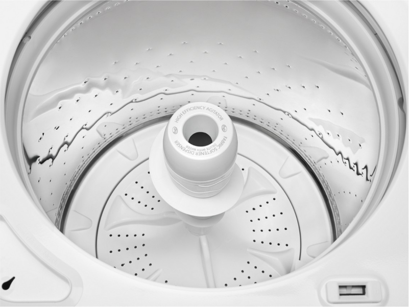 Open white top loading washer with an agitator