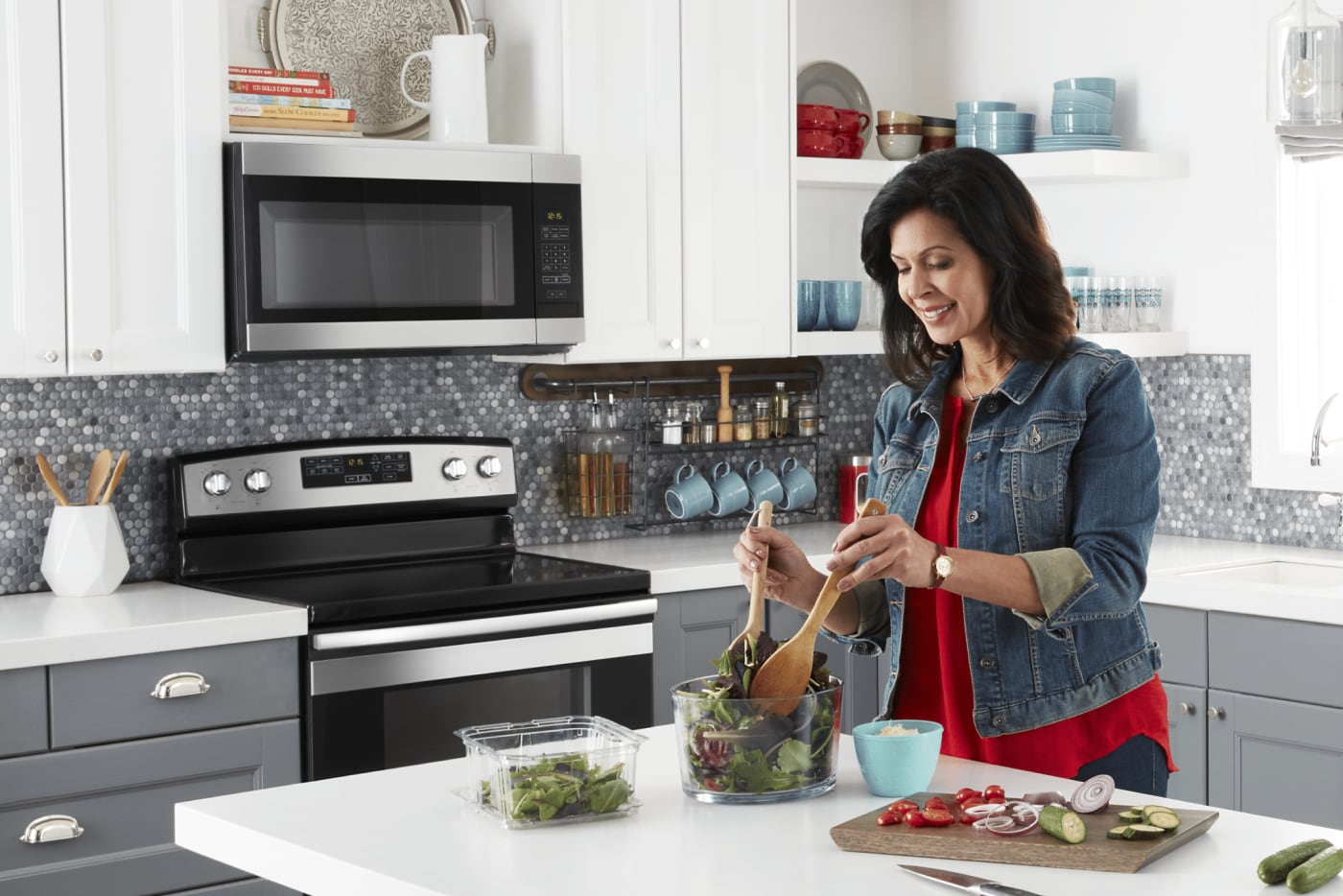 Woman making salad in a modern kitchen Woman making salad in a modern kitchen