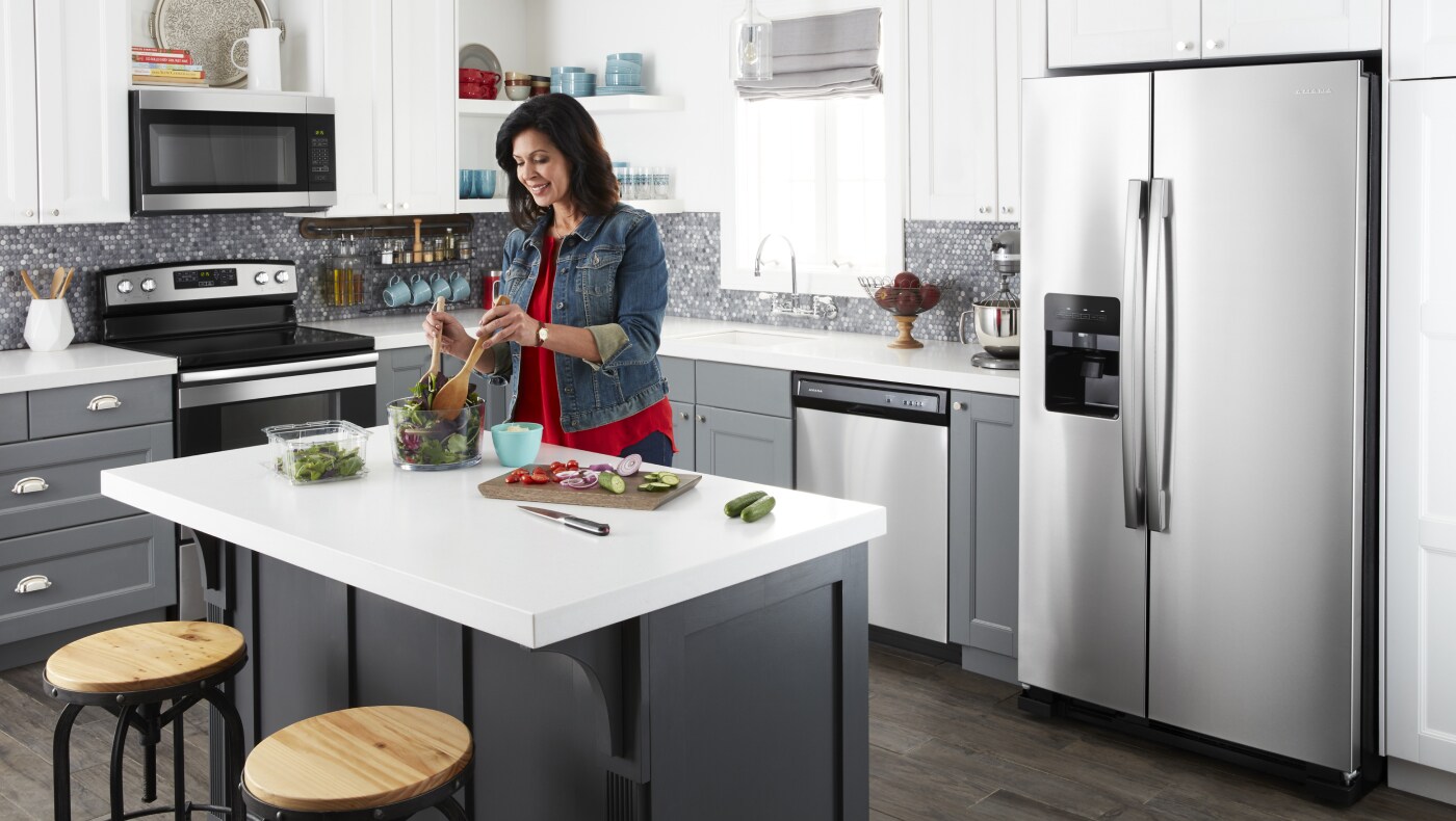 Person making a salad at the counter  Person making a salad at the counter