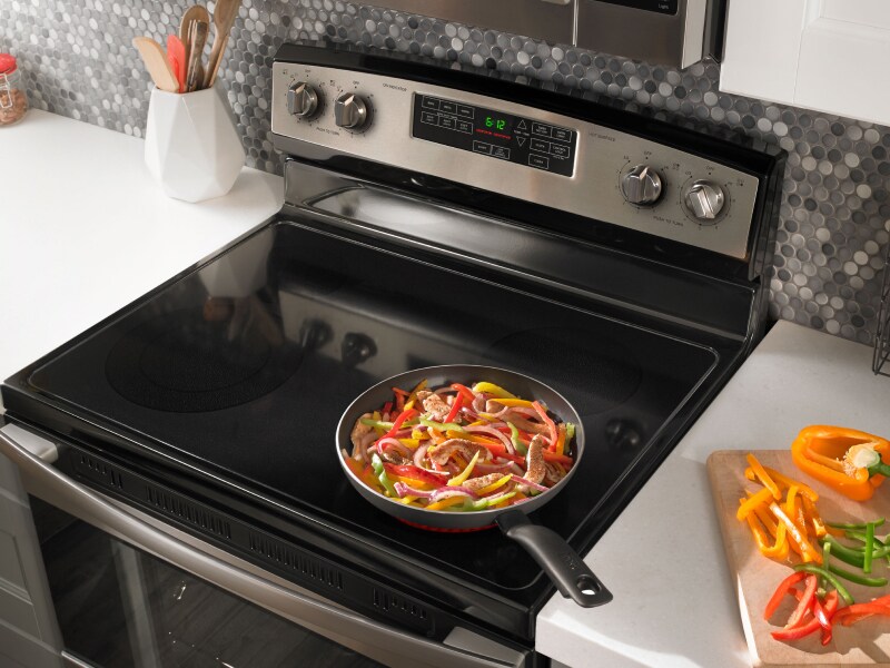 Food cooking on stovetop of stainless steel Amana® range Food cooking on stovetop of stainless steel Amana® range
