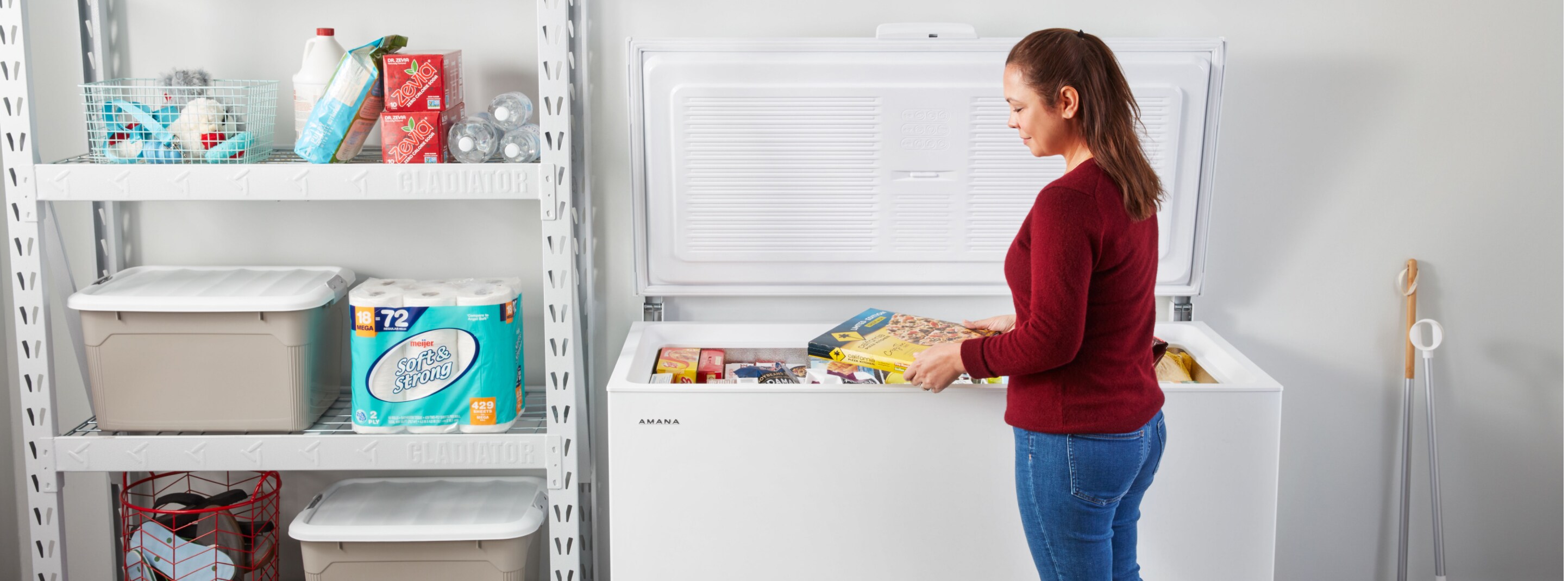 Person placing items in a chest freezer