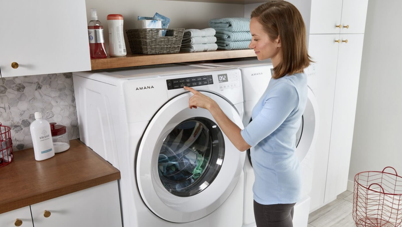 Person making a selection on a front load washing machine Person making a selection on a front load washing machine