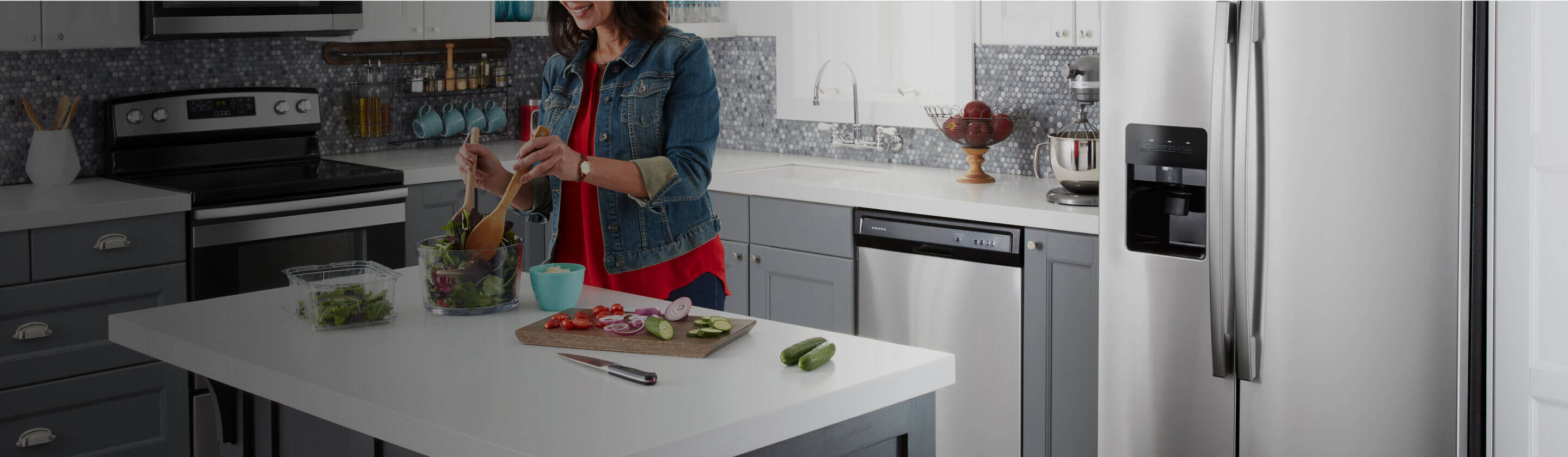 An Amana dishwasher and refrigerator in a kitchen.