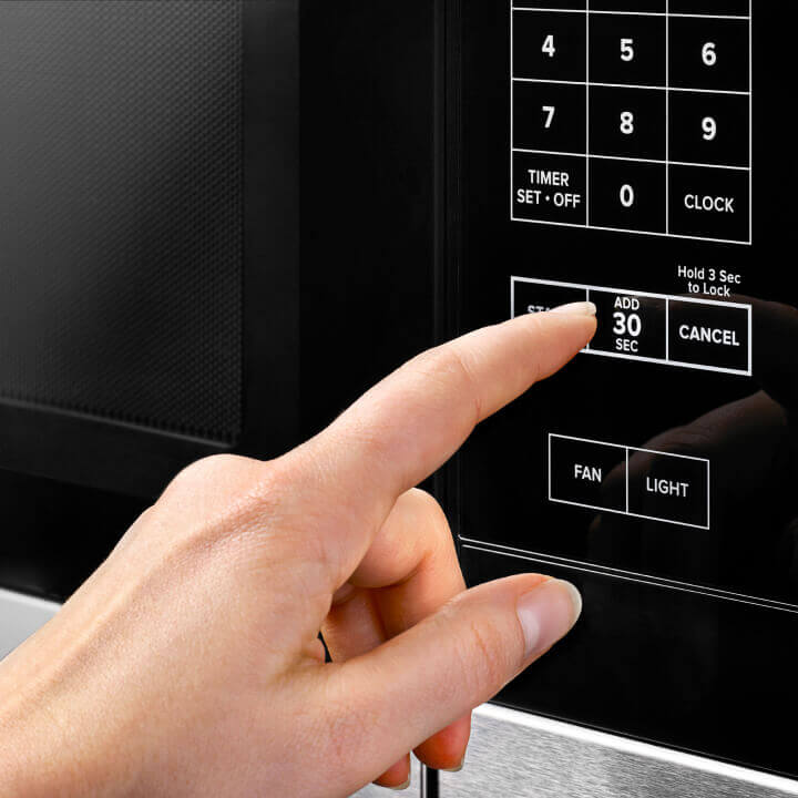 Person using microwave controls