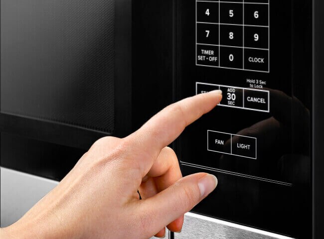Person using microwave controls