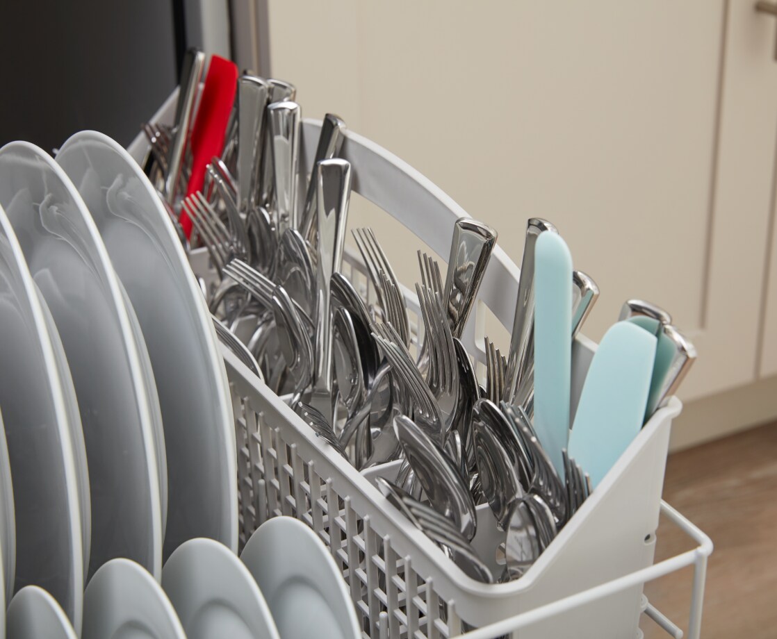Dishes inside an Amana brand dishwasher