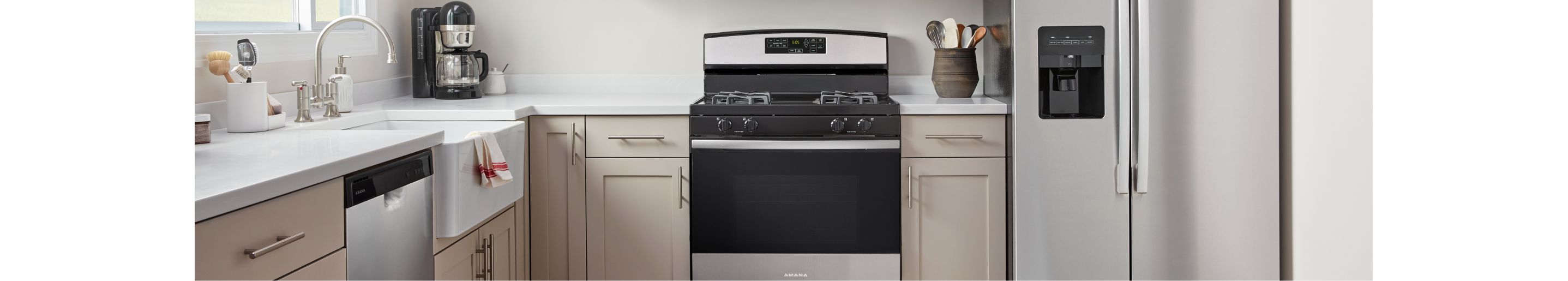 An Amana® dishwasher, range and refrigerator in a kitchen.