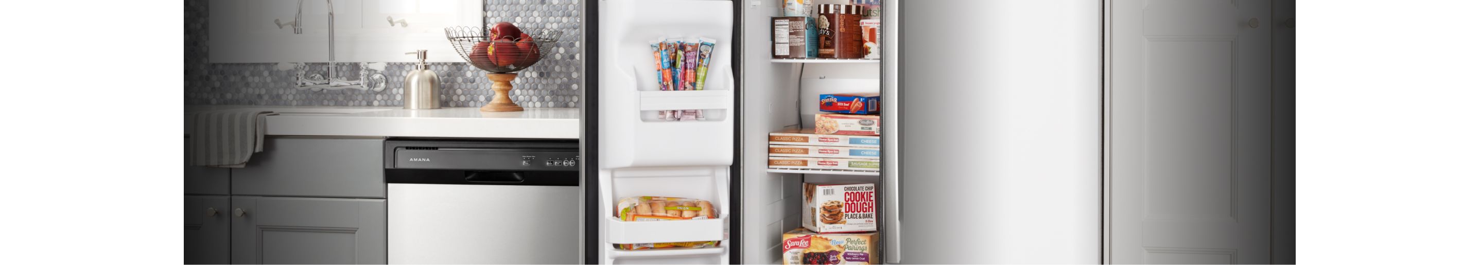 An Amana® dishwasher and open freezer door in a kitchen.