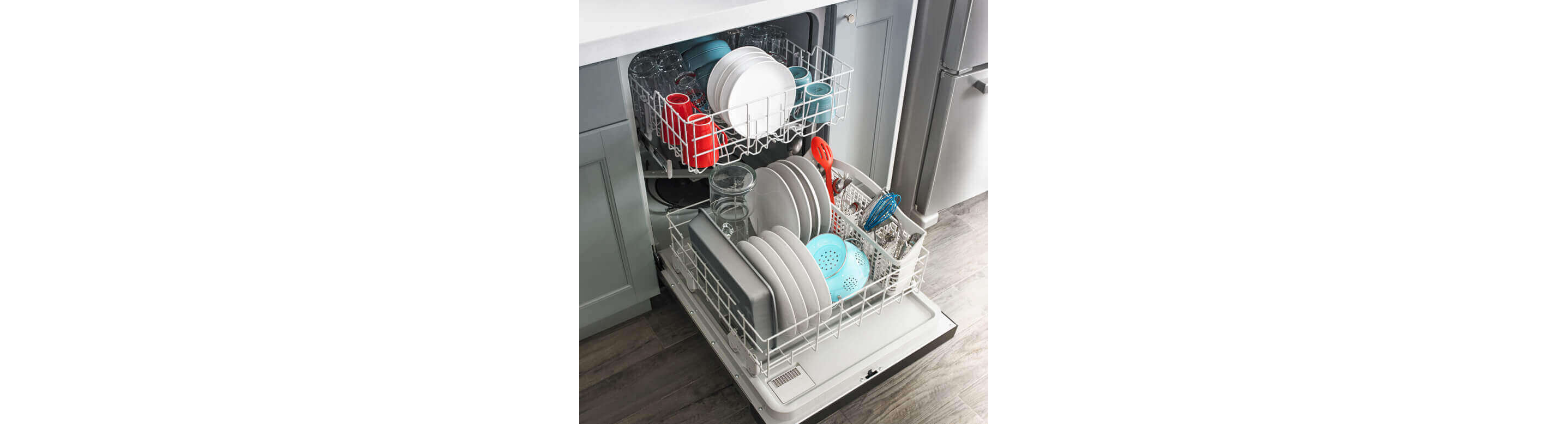 Amana® dishwasher loaded with dishes.