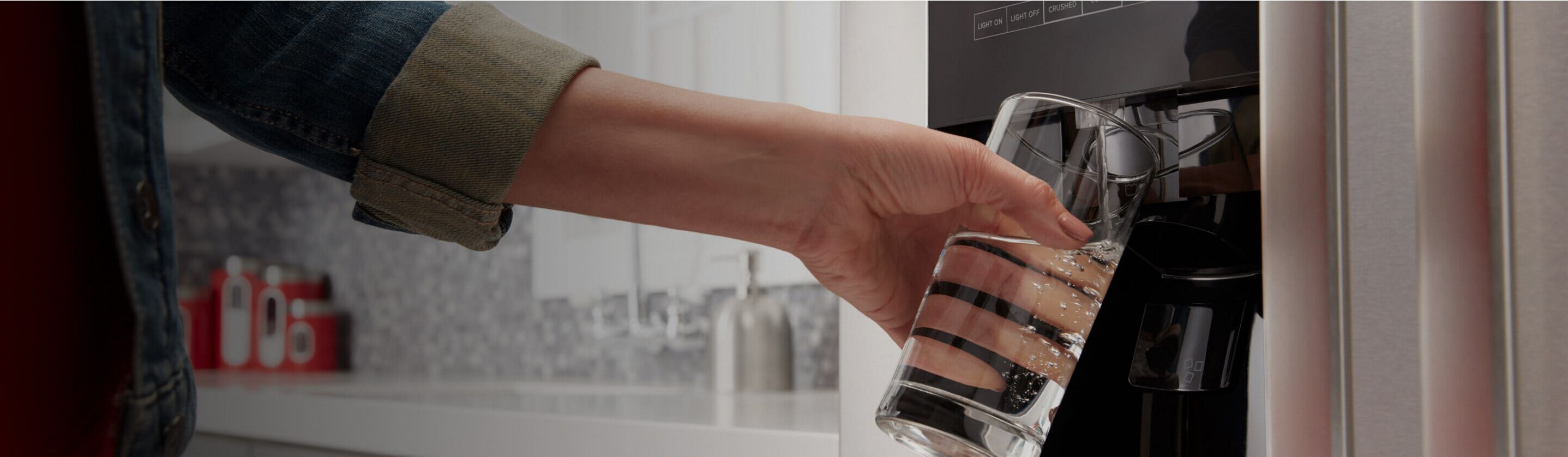 A person filling their glass with water.